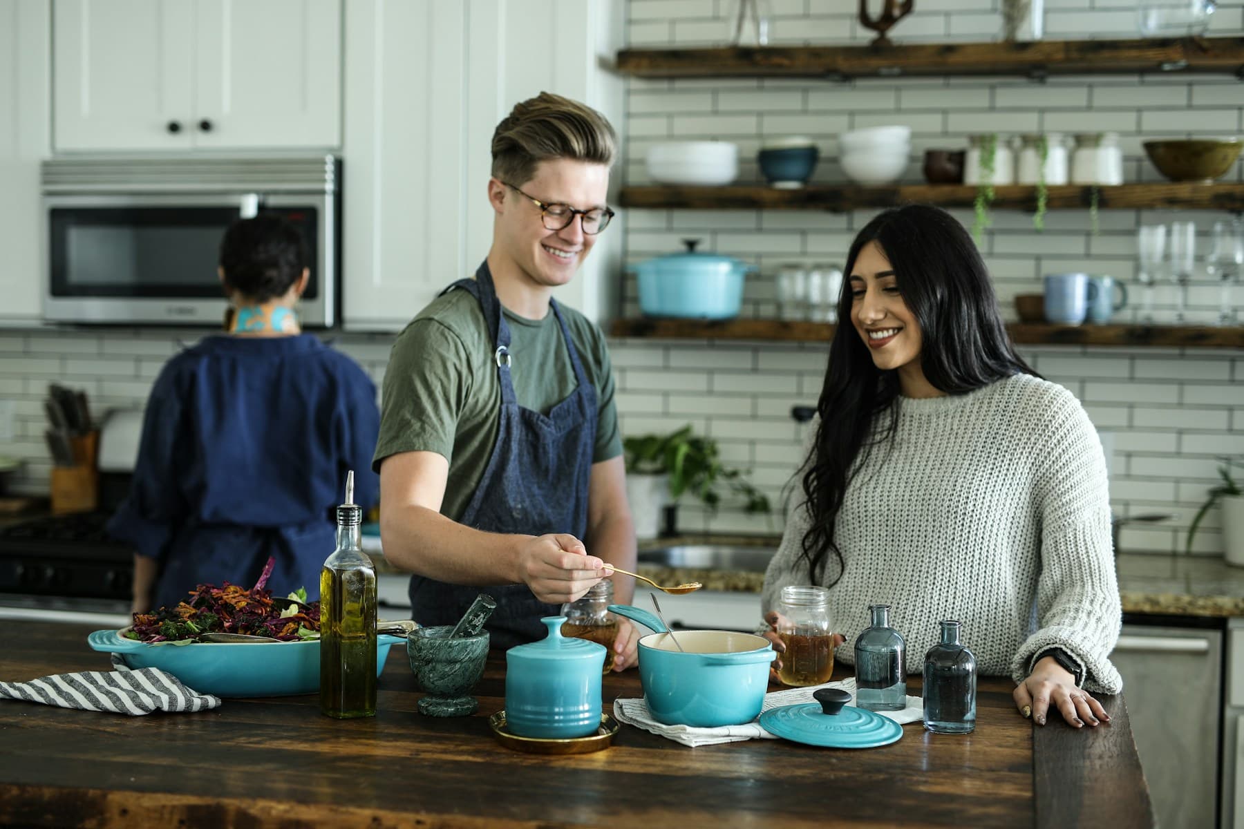 A couple cooking dinner together in their kitchen